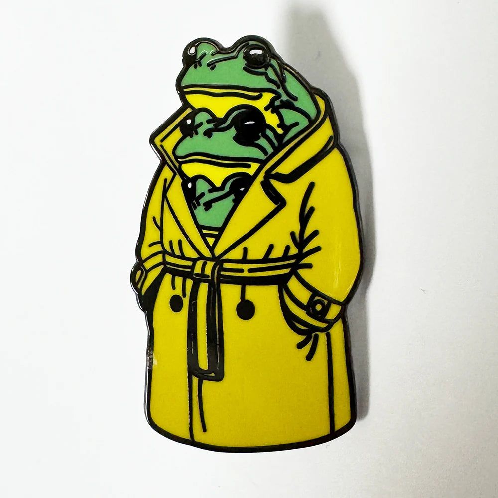 Three frogs in a trenchcoat enamel pin